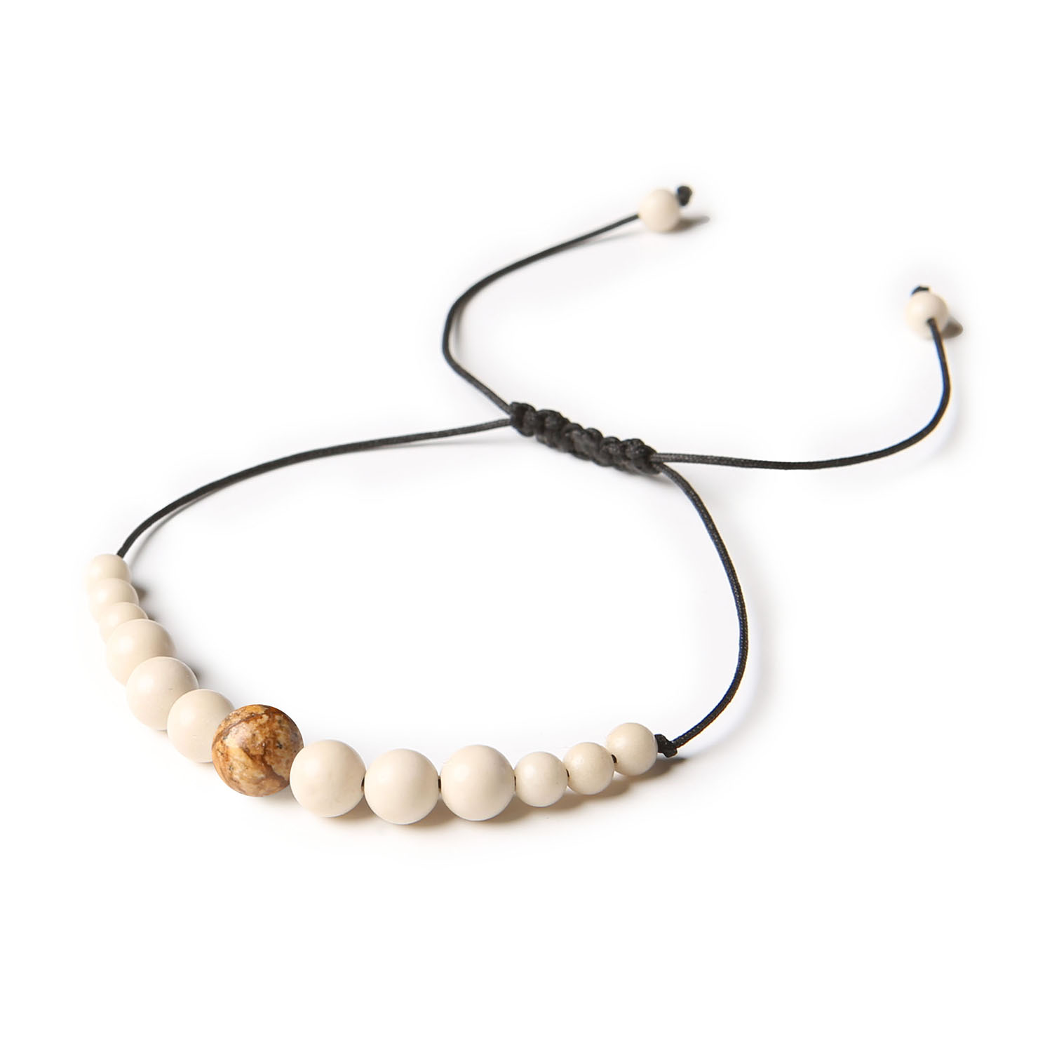 Uniwersalna bransoletka na sznurku z kolekcji Jaue, wykonana z jaspisu obrazkowego i kamienia rzecznego, dla dam oraz panów Bransoletka z kolekcji Jaue, wykonana z naturalnych kamieni jaspisu obrazkowego i kamienia rzecznego, dostępna w wersji damskiej i męskiej.